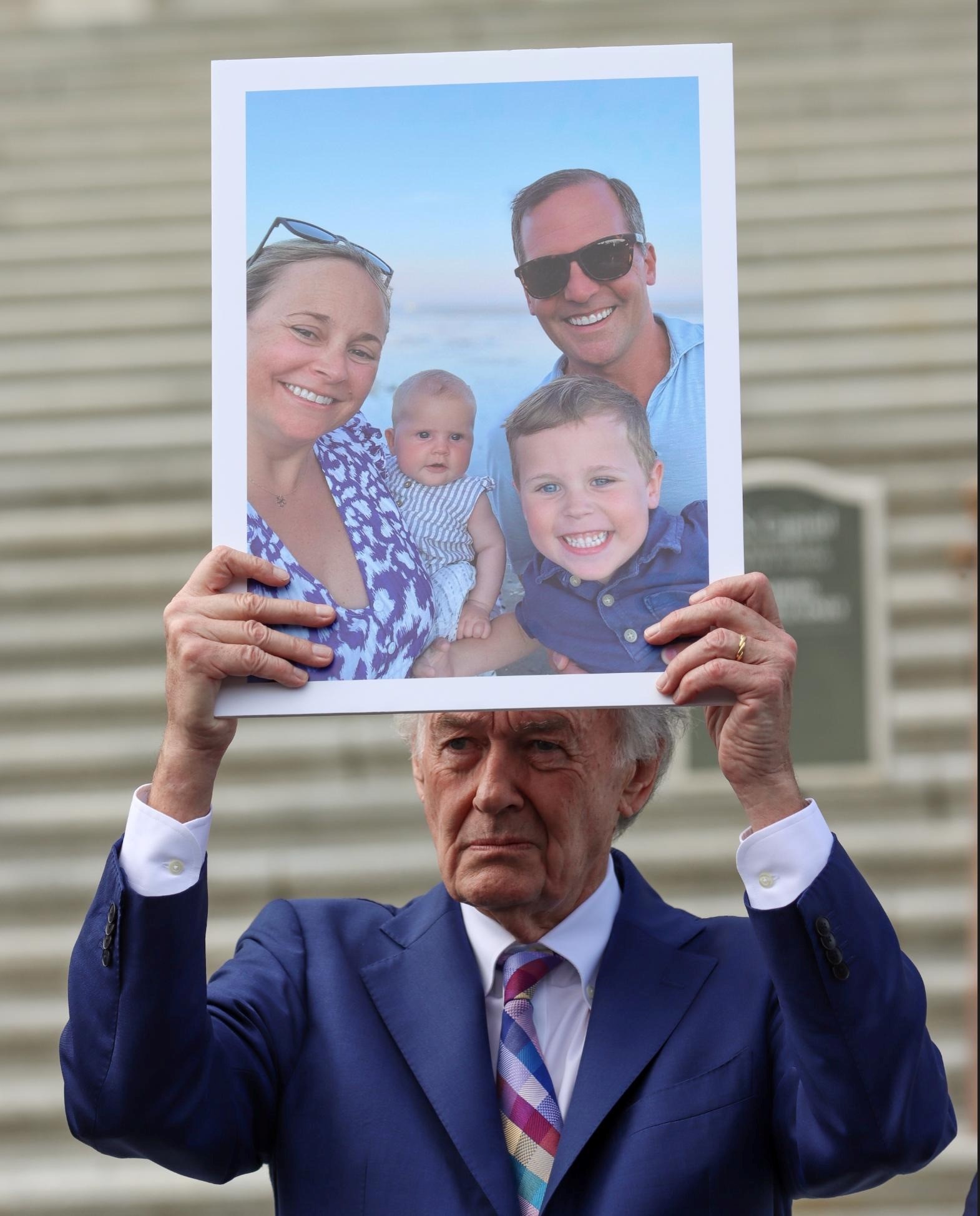 Senator Markey holding a picture of Kate Dineen and family